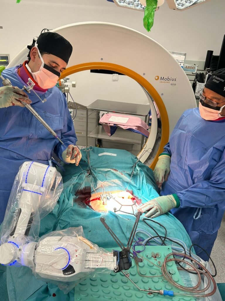 Robotic-assisted spinal instrumentation being performed using advanced navigation technology. The robotic guidance system supports the surgeon throughout implant placement while the operating surgeon remains in full control. Robotic-assisted spine surgery using advanced navigation and robotic guidance during spinal instrumentation